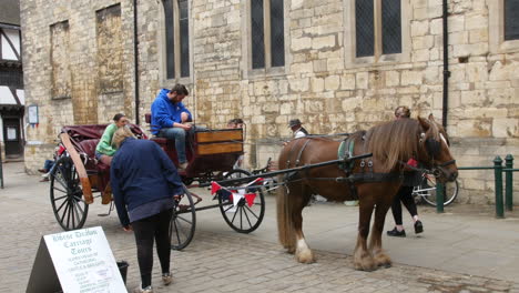 A-horse-drawn-carriage-tour-in-the-traditional-historic-town-of-Lincoln-in-England