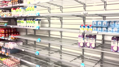 Display-with-partly-empty-shelves-showing-shelf-stable-dairy-alternative-products-in-Dutch-supermarket-during-a-distribution-center-strike