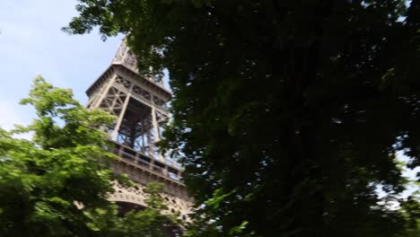 Ground-view-of-the-Eiffel-Tower-through-the-Parc-du-Champ-de-Mars,-Paris,-France
