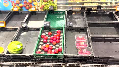 Only-few-fruits-left-in-otherwise-empty-crates-in-Dutch-supermarket-during-a-distribution-center-strike