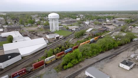 Train-moving-down-the-tracks-in-Muncie,-Indiana-with-stable-drone-video