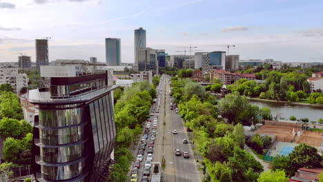 Bucharest-office-district,-city-skyline-with-rush-hour-traffic,-aerial-view,-Bucharest-Romania