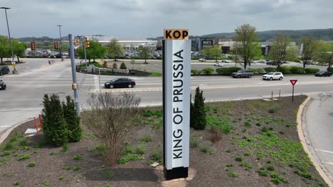 Rotational-aerial-shot-of-King-of-Prussia-signage-outside-major-American-shopping-mall-and-outlet-stores