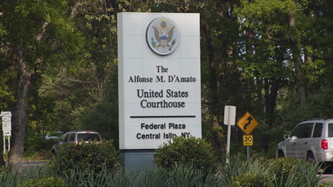 Central-Islip-New-York-Federal-Courthouse-Exterior-Entrance-Sign-with-Cars-Driving