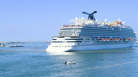 Closeup-shot-of-Luxury-cruise-ship-Carnival-Vista-Sailing-from-Port-of-Miami,-Florida,-USA-|-Cruise-Vacation-in-Carnival-video-background-|-Carnival-Cruise-ship-sailing-in-Caribbean-sea