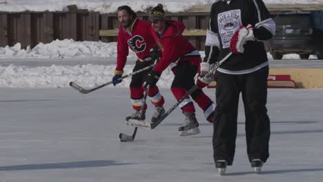 Slow-motion-shot-of-hockey-player-stickhandling-puck-at-pond-hockey-tournament