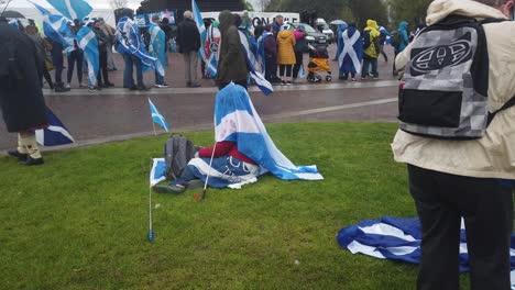 A-woman-covering-herself-with-the-Saltire-to-keep-her-dry