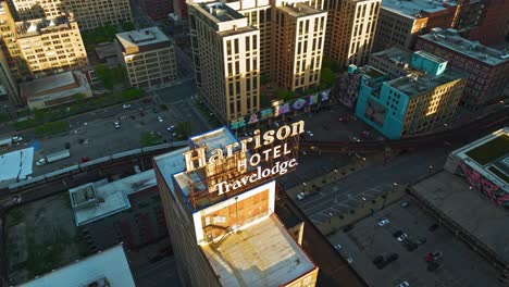 Aerial-view-following-a-train-passing-the-Suffrage-Mural,-sunrise-in-Chicago,-USA