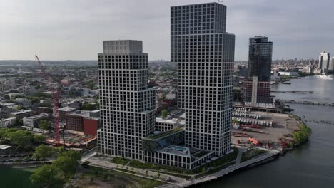 An-aerial-view-of-the-Eagle-and-West-apartment-buildings-in-Greenpoint,-Brooklyn-on-a-sunny-day-from-over-the-East-River