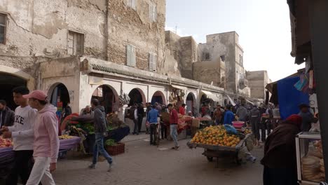 Busy-street,-local-people-passing-by-street-market-in-Medina-of-Essaouira