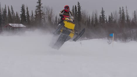 Snowmobile-racer-doing-a-catwalk-with-skidoo-in-blowing-snow