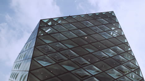 Static-shot-looking-to-the-top-of-glass-geometric-Prada-building,-Tokyo