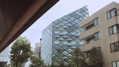 Static-street-ground-level-view-across-to-diamond-glass-window-Tokyo-Prada-building-in-downtown-Tokyo