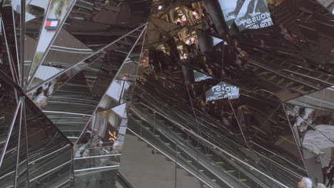 Abstract-mirrored-reflections-of-escalators-moving-staircases-in-luxury-Prada-store,-Tokyo