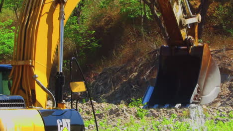 Washing-Backhoe-and-Cement-Mixer-Truck-Near-the-River