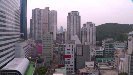 Tilt-down-from-the-Haeundae-beach-Grand-Hotel-in-Busan,-South-Korea-to-other-buildings