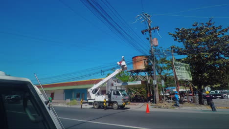 Old-Rusty-Basket-Truck-with-Linemen-is-fixing-the-Power-Transmission-Lines,-Philippines