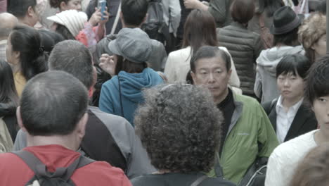 Close-shot-as-tourists-and-locals-walk-down-a-crowded-street