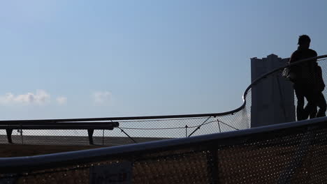 A-couple's-silhouette-walking-along-the-Rooftop-Plaza-at-Yokohama-International-Port-Terminal