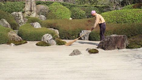 Famous-rock-garden-at-Meigetsu-in-being-tended-to-by-groundsman,-Kita-Kamakura,-Kanagawa,-Japan