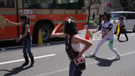 People-perform-dance-with-Japanese-fan-on-the-street-of-Kamamura-in-Japan