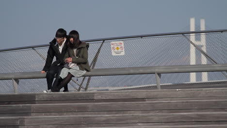 Das-Junge-Paar-Sitzt-Auf-Einer-Bank-Am-Internationalen-Hafenterminal-Von-Yokohama