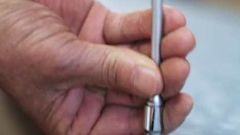 Carpenter-using-screwdriver-to-tighten-in-screw-in-Kamakura,-Japan