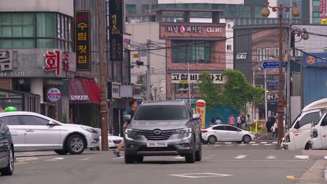 Tight-shot-of-lots-of-cars-on-a-road-in-Haeundea,-Busan,-South-Korea