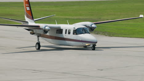 Small-plane-taxxing-off-of-runway-onto-tarmac-at-airport