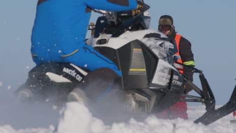 Skidoo-snowmobile-drag-races-at-start-line-with-green-light-in-slow-motion