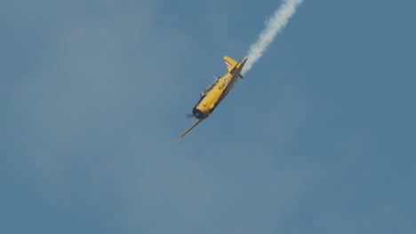 Close-up-North-American-Harvard-Mark-IV-airplane-pulling-out-of-steep-dive-at-airshow-in-slow-motion