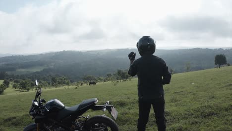 4k-slow-mo-panning-shot-around-a-motorcycle-rider-on-a-hill-top-mountain
