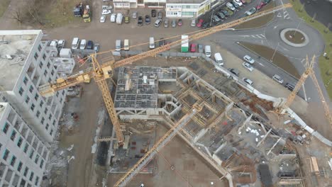 High-yellow-crane-moving-over-a-construction-site-in-a-new-residential-urban-modern-area