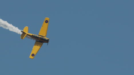 Close-up-of-North-American-Harvard-Mark-IV-airplane-rolling-out-of-turn-at-airshow-in-slow-motion
