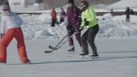 Blonde-female-hockey-player-playing-outdoor-pond-hockey