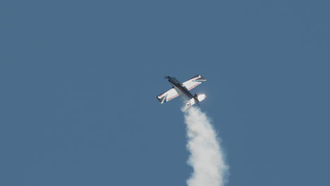 Close-up-of-F1-Rocket-or-Harmon-Rocket-II-airplane-entering-turning-stall-or-hammerhead-turn-at-airshow-with-thick-smoke-in-slow-motion