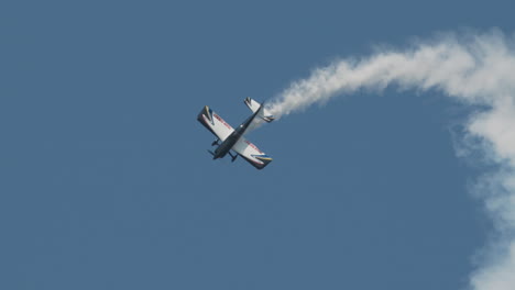 Close-up-of-F1-Rocket-or-Harmon-Rocket-II-airplane-exiting-a-stall-and-diving-with-huge-smoke-trail-at-an-airhshow-in-slow-motion
