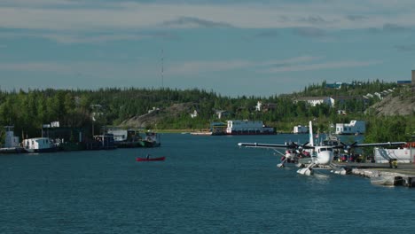 Person-in-canoe-paddles-across-harbor.-Wide-shot