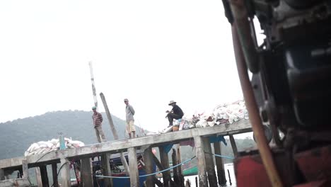 Three-adults-facing-the-camera-on-a-Pier