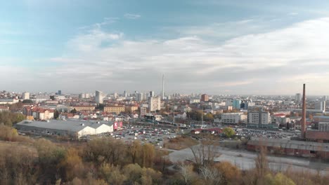 Drone-came-from-a-nature-forest-tree-and-fly-over-the-busy-city-of-Zagreb-with-shopping-center-and-traffic