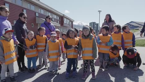 Primary-School-Children-Lined-Up-Outside-In-Playground-With-Their-Teachers