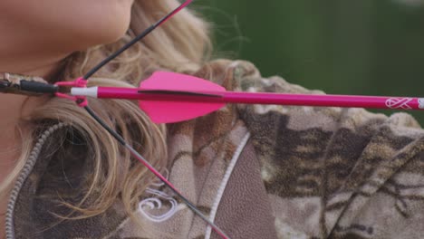 Extreme-closeup-of-female-archer-pulling-back-on-bow-to-aim
