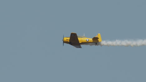 Close-up-of-North-American-Harvard-Mark-IV-airplane-performing-flyby-at-airshow-in-slow-motion