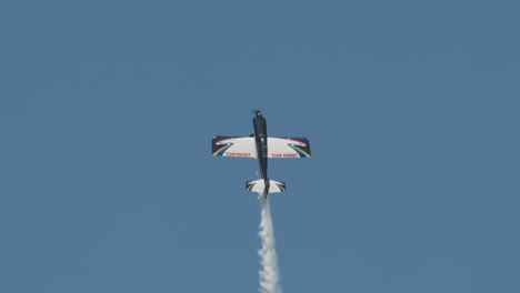 Close-up-of-F1-Rocket-or-Harmon-Rocket-II-airplane-in-a-steep-vertical-climb-with-smoke-trail-at-an-airshow-in-slow-motion