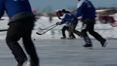Male-hockey-player-skates-past-opposing-team-to-score