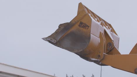 Loader-dumping-gravel-into-back-of-gravel-truck-trailer