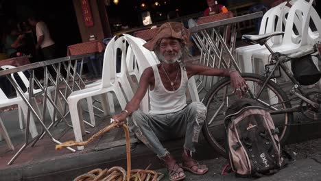 A-man-at-the-streetmarket-waving-with-his-snake