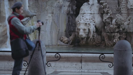 Clip-of-a-tourist-taking-photos-at-Fountain-of-the-Four-Rivers-in-Navona-Square-or-Piazza-Navona-in-Rome,-Italy