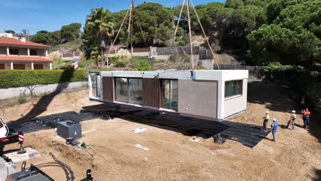 Team-workers-during-construction-of-new-and-modern-modular-pre-fabricated-house