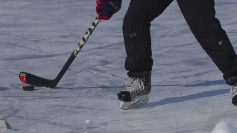 Slow-motion-close-up-of-hockey-stick-handling-puck